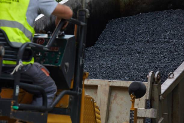 istock Industrial pavement machine laying fresh asphalt on road construction. 986566510
