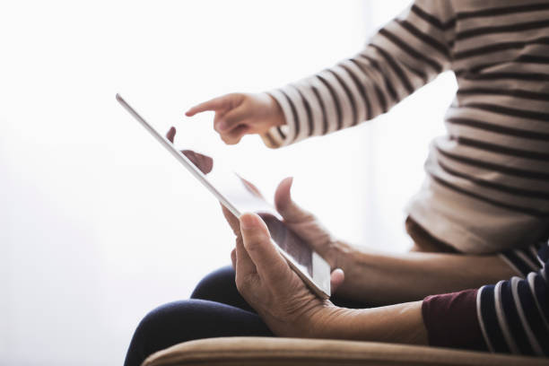 babcia i chłopiec za pomocą cyfrowego tabletu razem w domu - grandmother child grandparent hope zdjęcia i obrazy z banku zdjęć