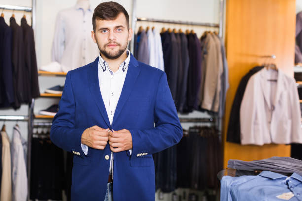 istock man  choosing  fashion jacket 986567350