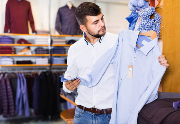 istock Guy choice  looking classic shirt in store 986567388