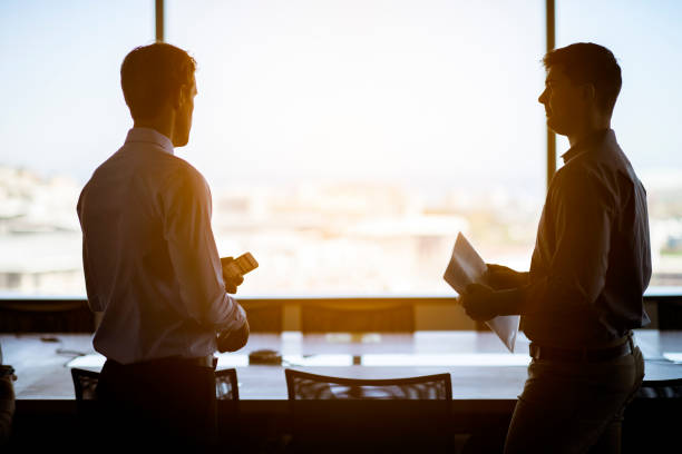 istock Male professionals discussing in board room 986567556