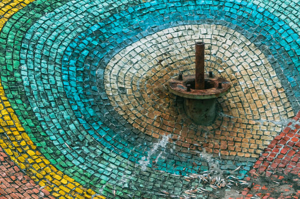 Abandoned fountain decorated with rainbow mosaic