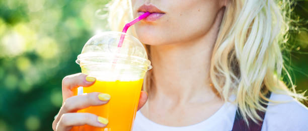 istock a girl drinks freshly squeezed juice, a healthy lifestyle 986570654