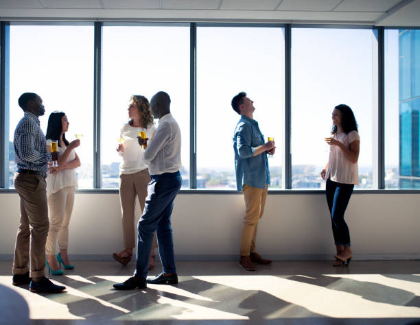 istock Entrepreneurs enjoying party by window at office 986573108