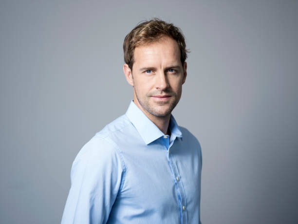 istock Confident businessman against gray background 986573594
