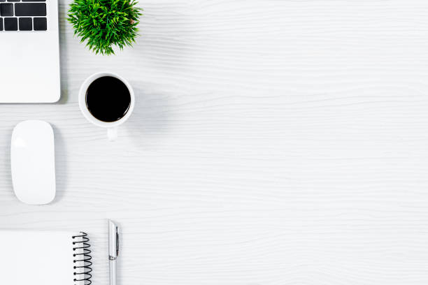 istock White wood office desk table and equipment for working with black coffee  in top view and flat ray concept. 986574272