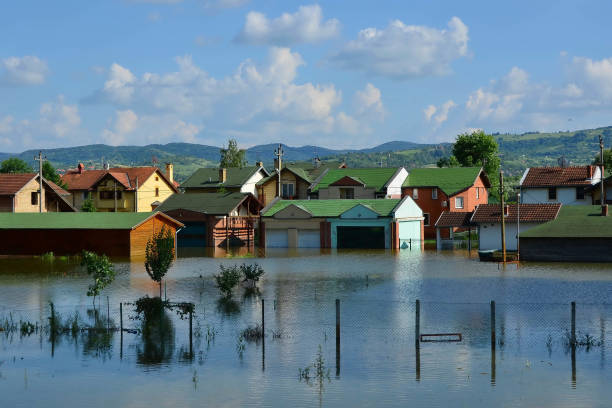 istock Flooded houses by the river 986580356