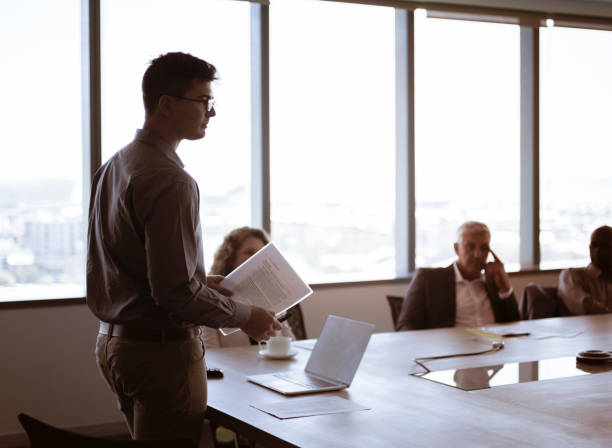 businessman holding document at table in office - board room business conference table window imagens e fotografias de stock