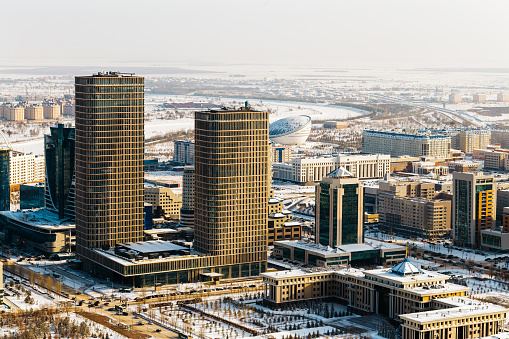 Ministry of Defense of the Republic of Kazakhstan and two towers of Talan Towers on a sunny day in Astana, Kazakhstan.