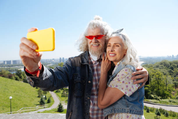istock Delighted aged couple taking selfies 986589510