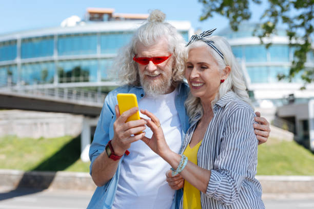 istock Positive joyful couple looking at the smartphone screen 986593712