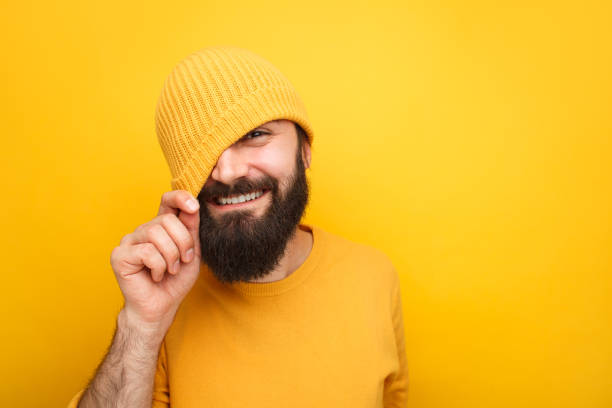 istock Handsome playful hipster in colorful hat 986594304