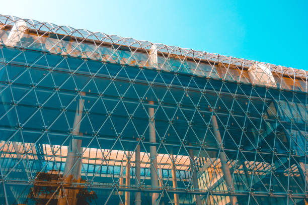 istock futuristic office building glass facade in cold colors 986594972