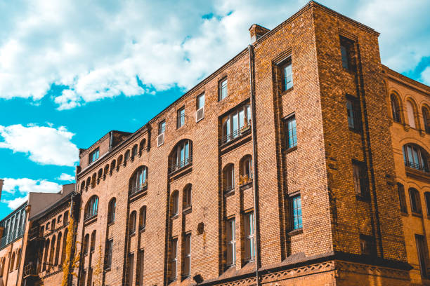 istock industrial brick building complex with white clouds in the background 986603420