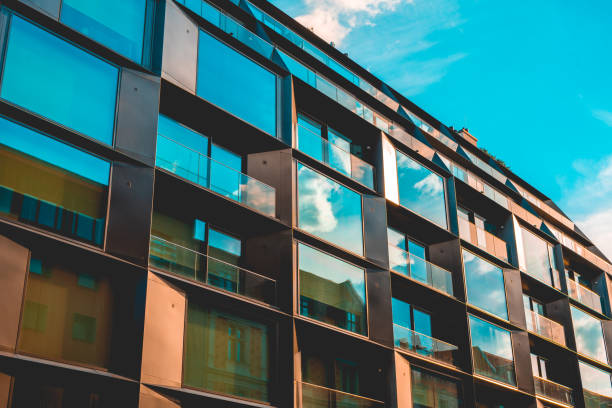 istock futuristic apartment house with cloud reflections in the windows 986613996