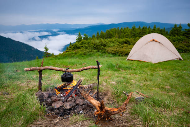 istock Old small kettle is heated on a bonfire 986615360