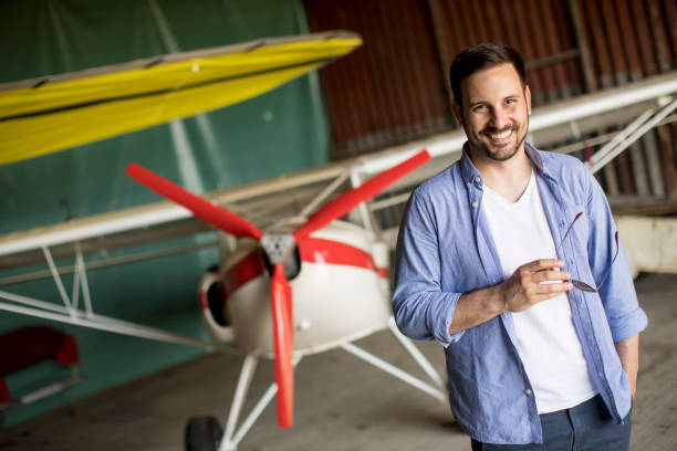istock Young man in the airplane hangar 986615446