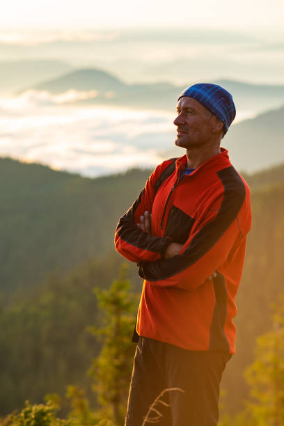 istock Happy adventurer on the mountain top 986620356
