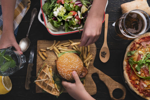 istock View from above the table of friends eating 986629094