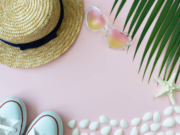 istock Straw summer hat, starfish, shells, heart-shape sunglasses, white sneakers and palm leaf 986631870