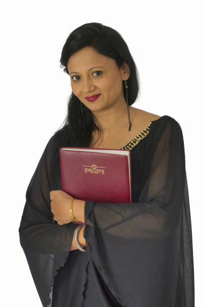 istock Smiling woman in black salwar suit holding a book 986635252