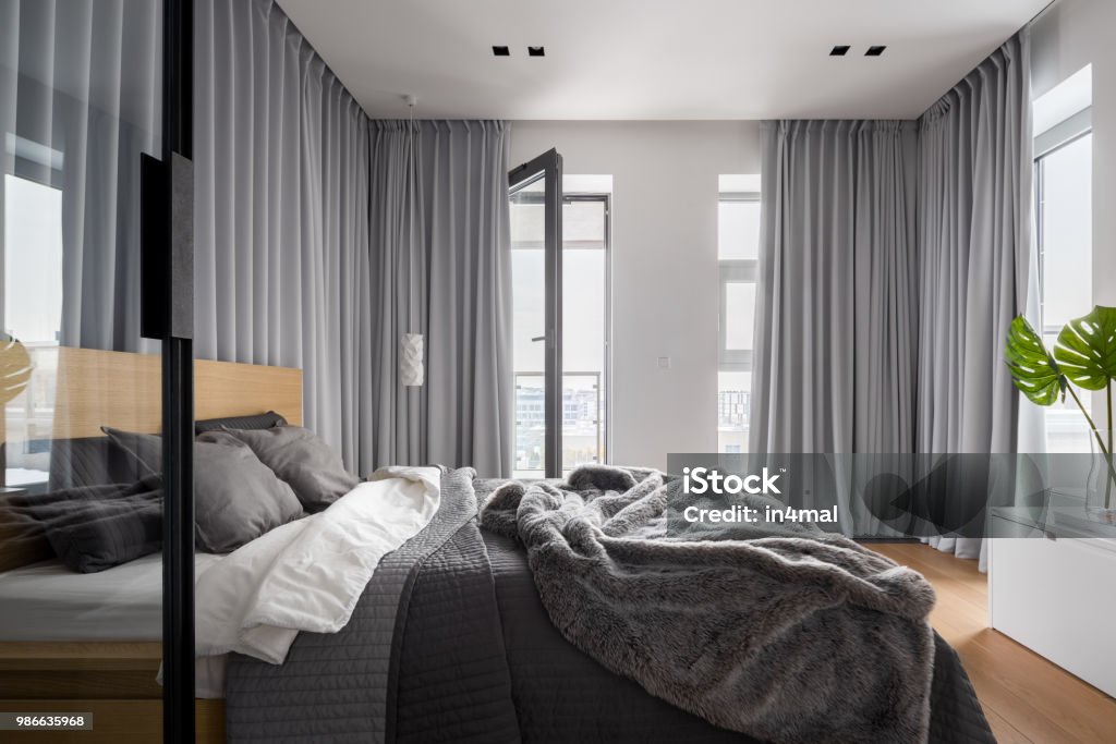 Luxury bedroom interior Luxury bedroom interior with double bed and gray window curtains Curtain Stock Photo