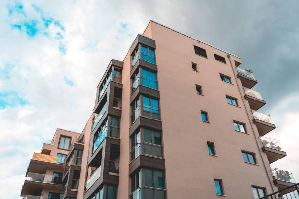istock orange colored apartment house with glass balcony 986636230