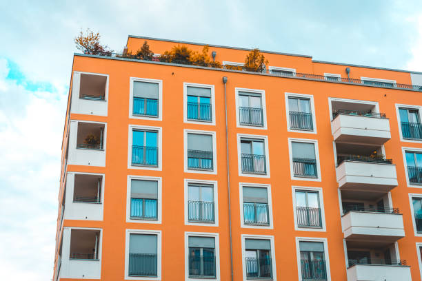 istock orange facaded apartment house with white details 986641714