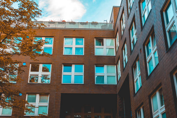 istock brick facaded apartment building with square windows in darken colors 986646388