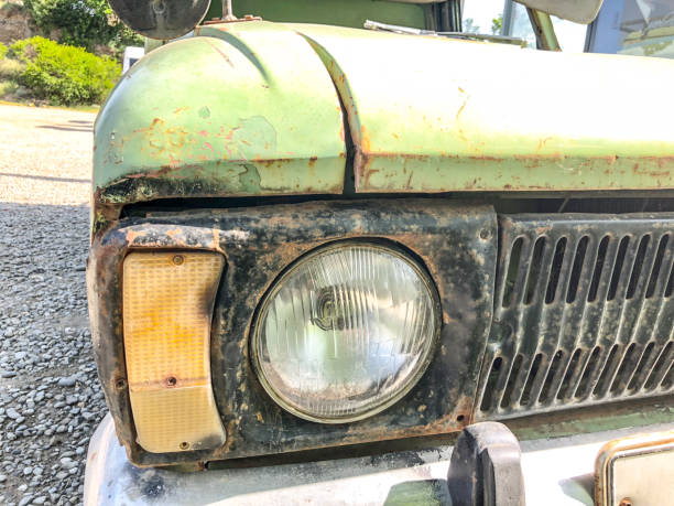 istock An old iron rusty car with an old headlight from the front. Close up shot 986649990