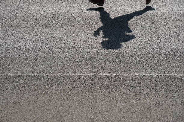 istock shadow of an unrecognizable runner on asphalt 986650882