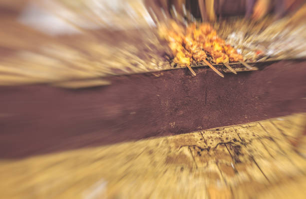 Marinated shashlik preparing on a barbecue grill over charcoal.  Traditional roasted stacked meat Shish kebab popular in Goergia. Blure effect