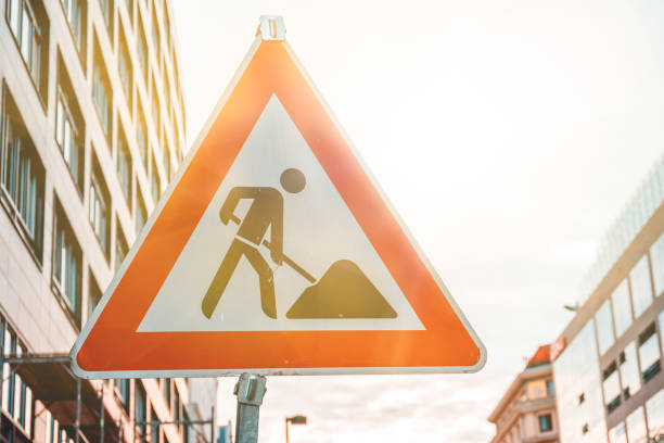 istock triangle building site traffic sign in warm sunlight 986656870