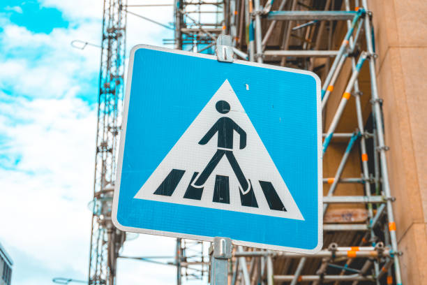 istock blue pedestrians traffic sign on building site background 986656944