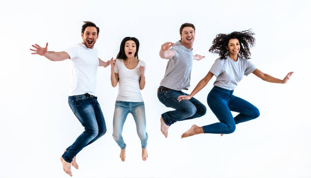 istock The four happy people jumping on the white background 986657220