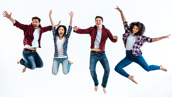 The four happy people jumping on the white background
