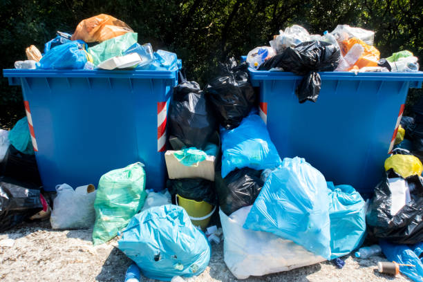 istock Overflowing Waste Collection Bins Outdoors 986660782
