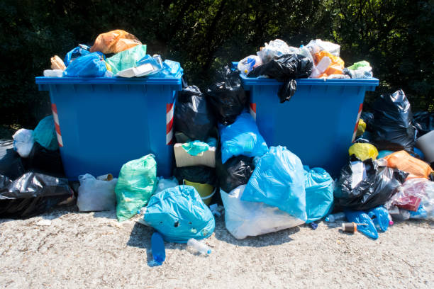 istock Overflowing Waste Collection Bins Outdoors 986660980