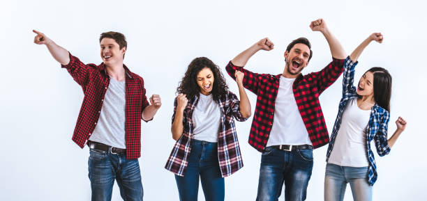 istock The happy four people gesturing on the white wall background 986661390