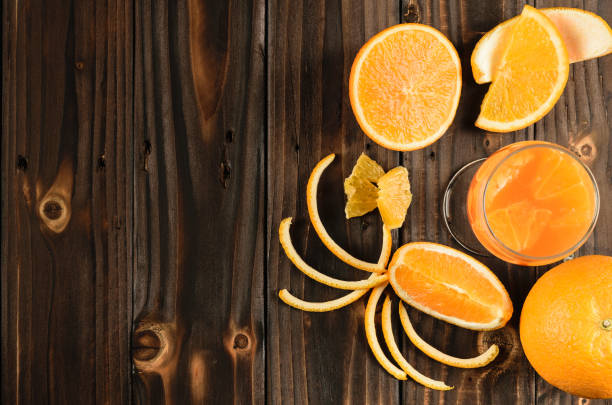 istock top view orange juice mandarin orange on  wood, copy space 986661624