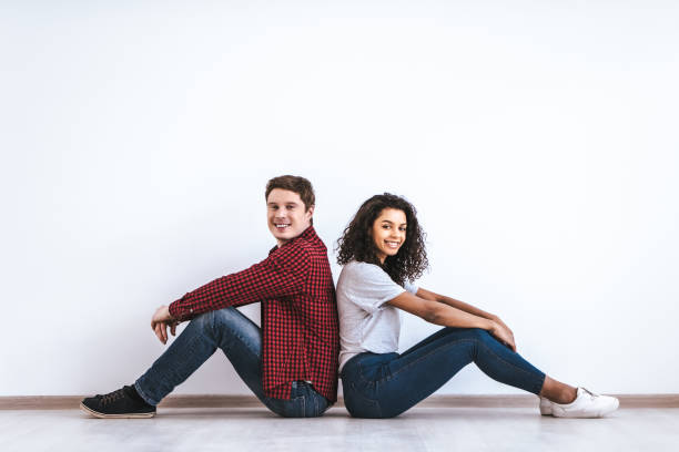 istock The attractive couple sitting on the floor 986661730