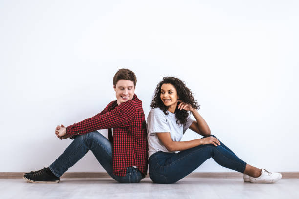 istock The attractive couple sitting on the floor 986661736