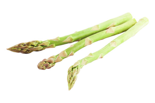 istock Three fresh green asparagus over white background with clipping path as a package design element, supermarket flyers and advertising 986665666