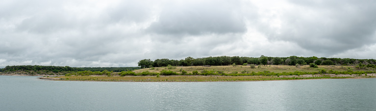 Panorama of Small Hill By Large Lake wit Storm Clouds