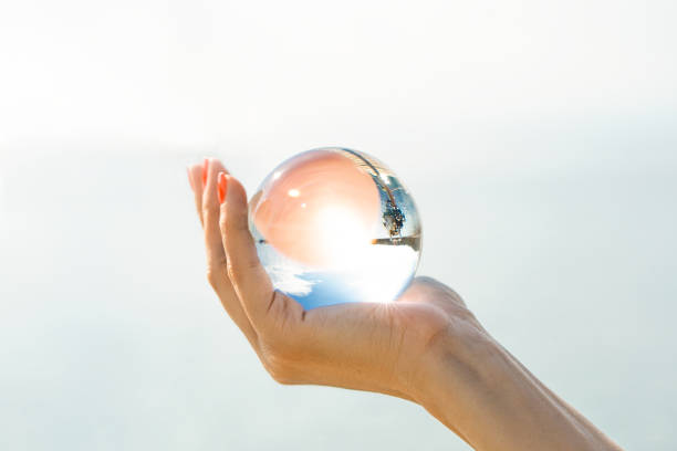 istock A female hand holds a glass ball 986667834