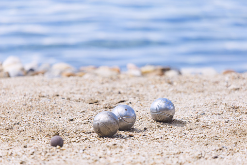 A game of bocce on the beach during the holiday season. Concept active rest