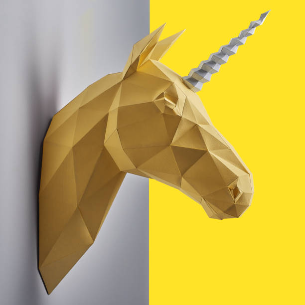 istock Fancy saturated yellow unicorn's head made of paper. 986669874