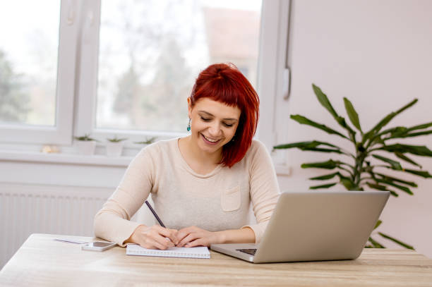 istock Young woman studying at home. 986674550