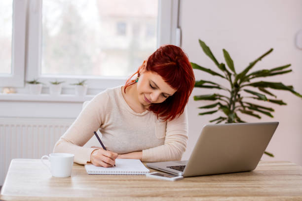 istock Busy woman in office doing paperwork 986674576