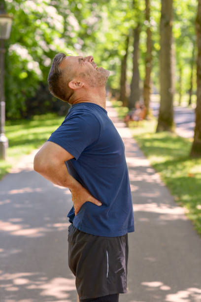 istock Mature man holding his painful back after running 986679030
